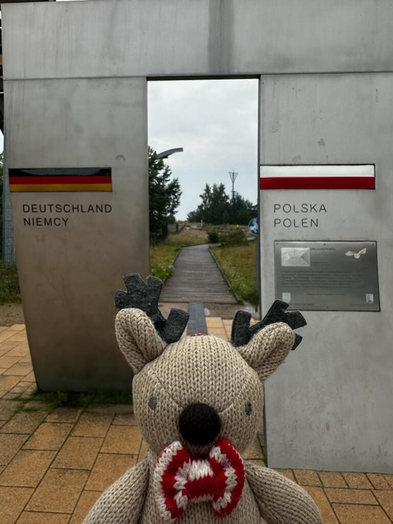 Rupert the reindeer standing at the marker between Germany and Poland