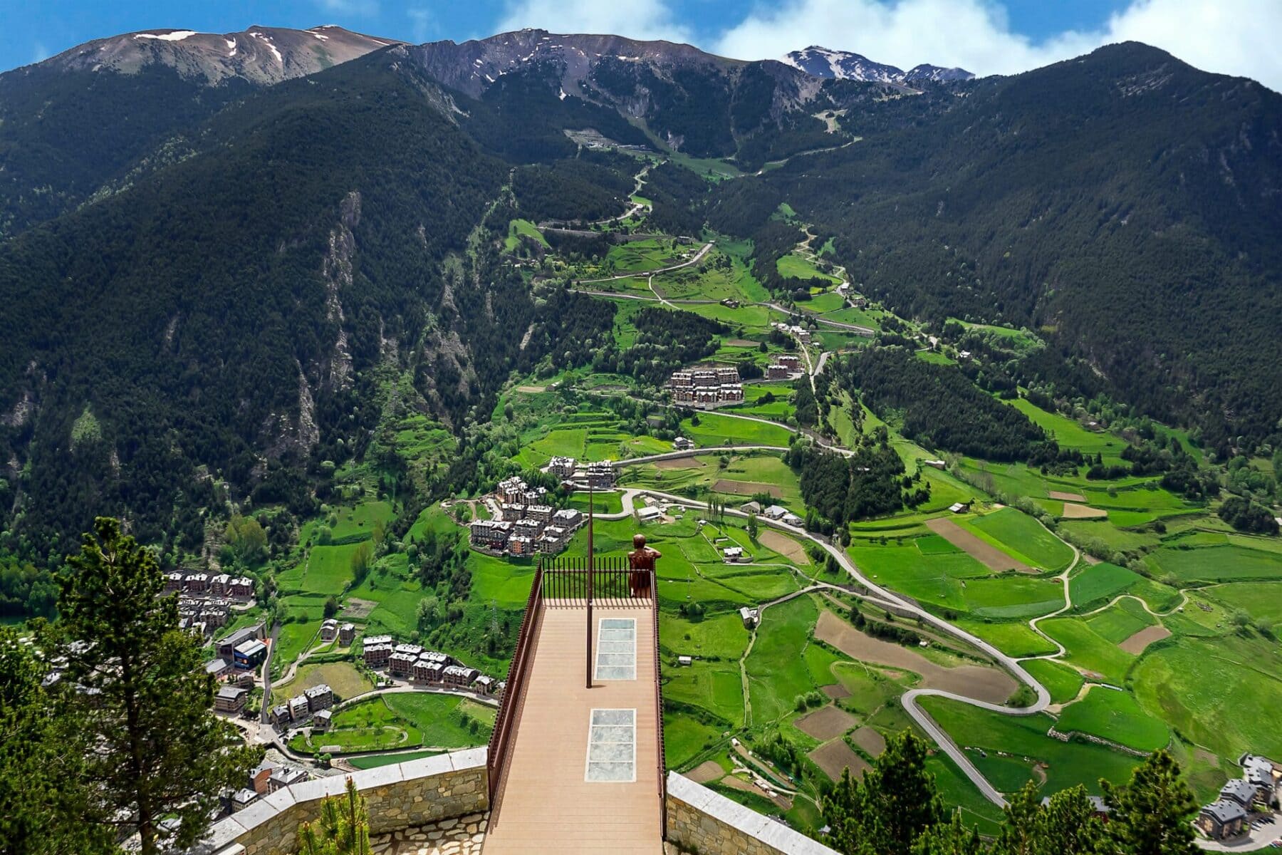 Scenic viewpoint overlooking a green valley and mountains in Andorra.