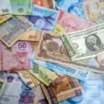 Assorted international banknotes from different countries, symbolising global travel and the need for currency converter apps.