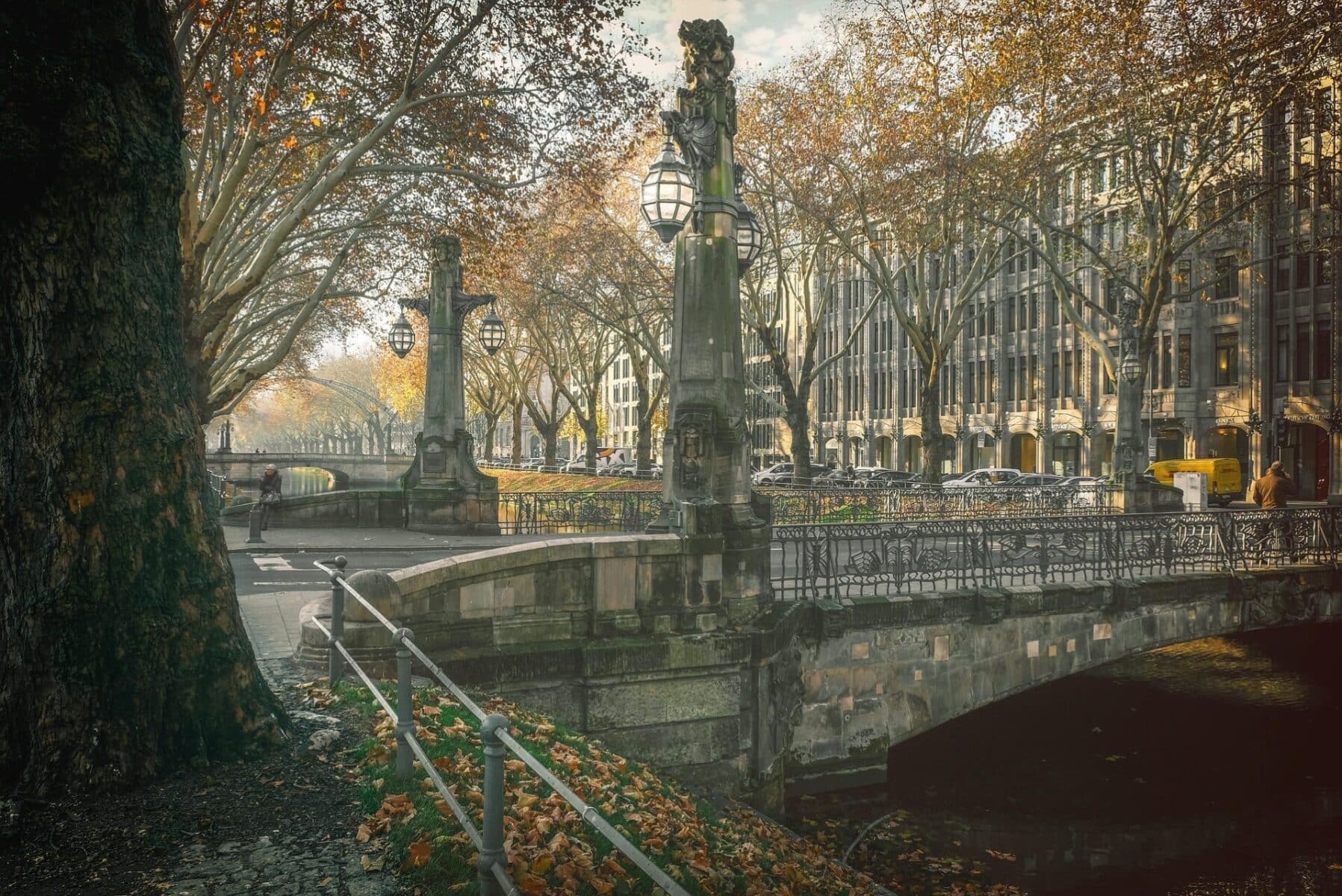 Autumn view of Königsallee canal and historic bridge in Düsseldorf