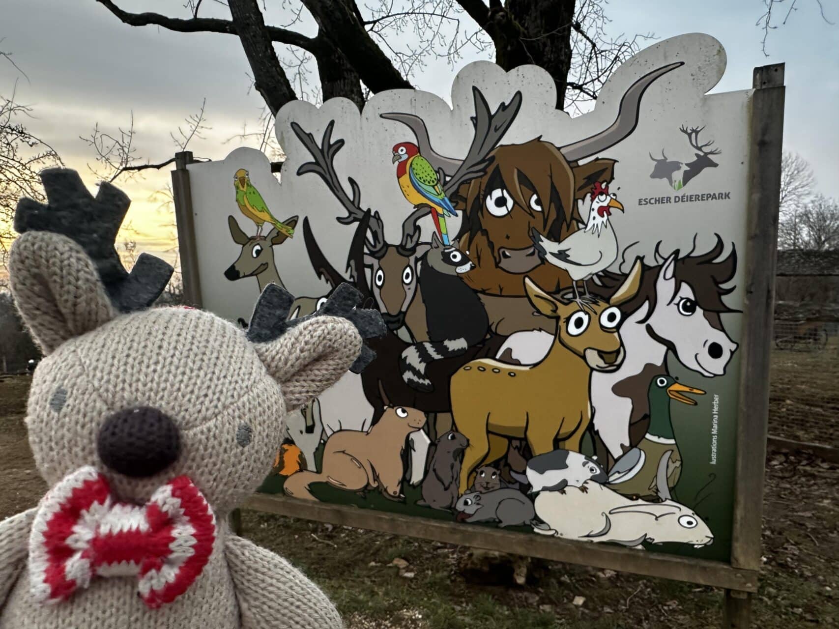 Rupert the reindeer by a colourful animal sign at Escher Déierepark