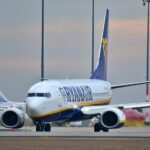 Ryanair Boeing 737 aircraft on airport tarmac with blue and yellow livery and company branding