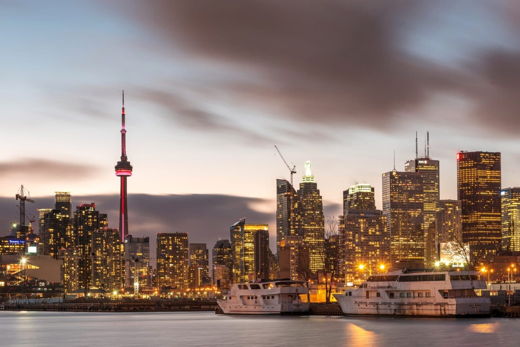 Toronto skyline at night with CN Tower and illuminated buildings