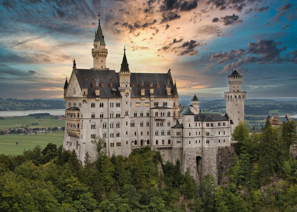 Neuschwanstein Castle perched above the Bavarian countryside at sunset