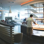 Modern airport lounge with seating and buffet service