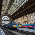 Interior view of Budapest Keleti Railway Station with trains on the platform under the grand glass roof