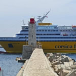 Corsica Ferries Mega Express Two passing a lighthouse in port