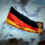 German flag waving in the wind against a dramatic sky
