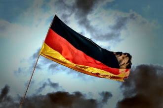 German flag waving in the wind against a dramatic sky