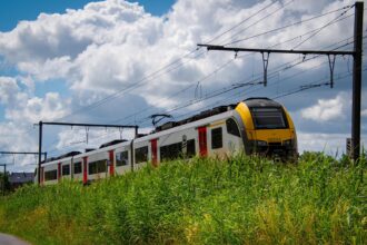 Belgian NMBS/SNCB train running through the countryside.