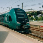Green Vy train at Sandefjord station in Norway.
