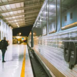 CP train at a station platform in Portugal at night.