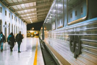 CP train at a station platform in Portugal at night.