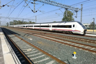 White Renfe long-distance train at a station in Spain.