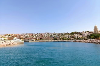 Scenic view of Aqabaโs marina and colourful waterfront buildings overlooking the Red Sea.