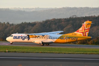 Aurigny Air Services ATR-72 aircraft in Guernsey livery taxiing at sunrise