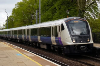 Elizabeth Line train approaching a station platform in London