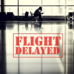 Passenger sitting in an airport terminal during a flight delay with large red “Flight Delayed” sign overlay.