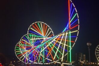 Cycle light installation with rainbow spirals at River of Light Liverpool 2025, part of the Science of Light trail