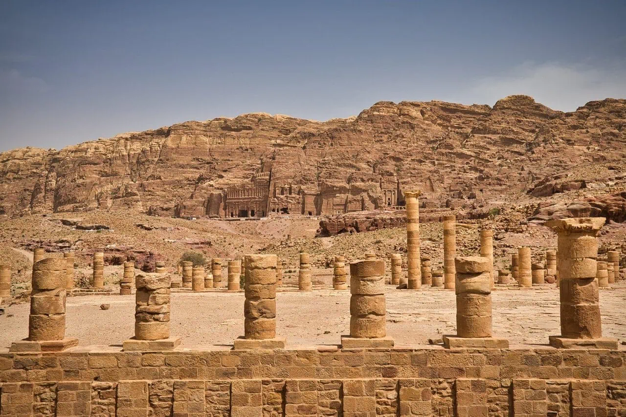 Ancient colonnaded street in Petra with Royal Tombs visible in the background, Jordan