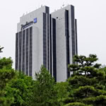 Radisson Blu hotel surrounded by green trees.