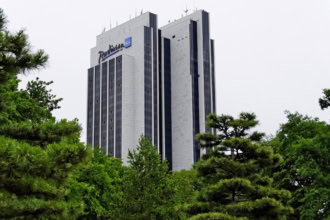 Radisson Blu hotel surrounded by green trees.