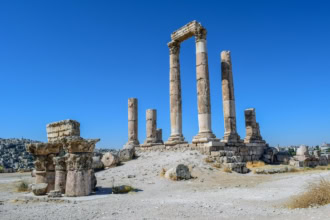 Temple of Hercules ruins at Amman Citadel under clear blue sky
