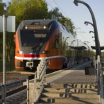 Estonian electric train at a modern station platform at sunset