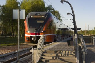 Estonian electric train at a modern station platform at sunset