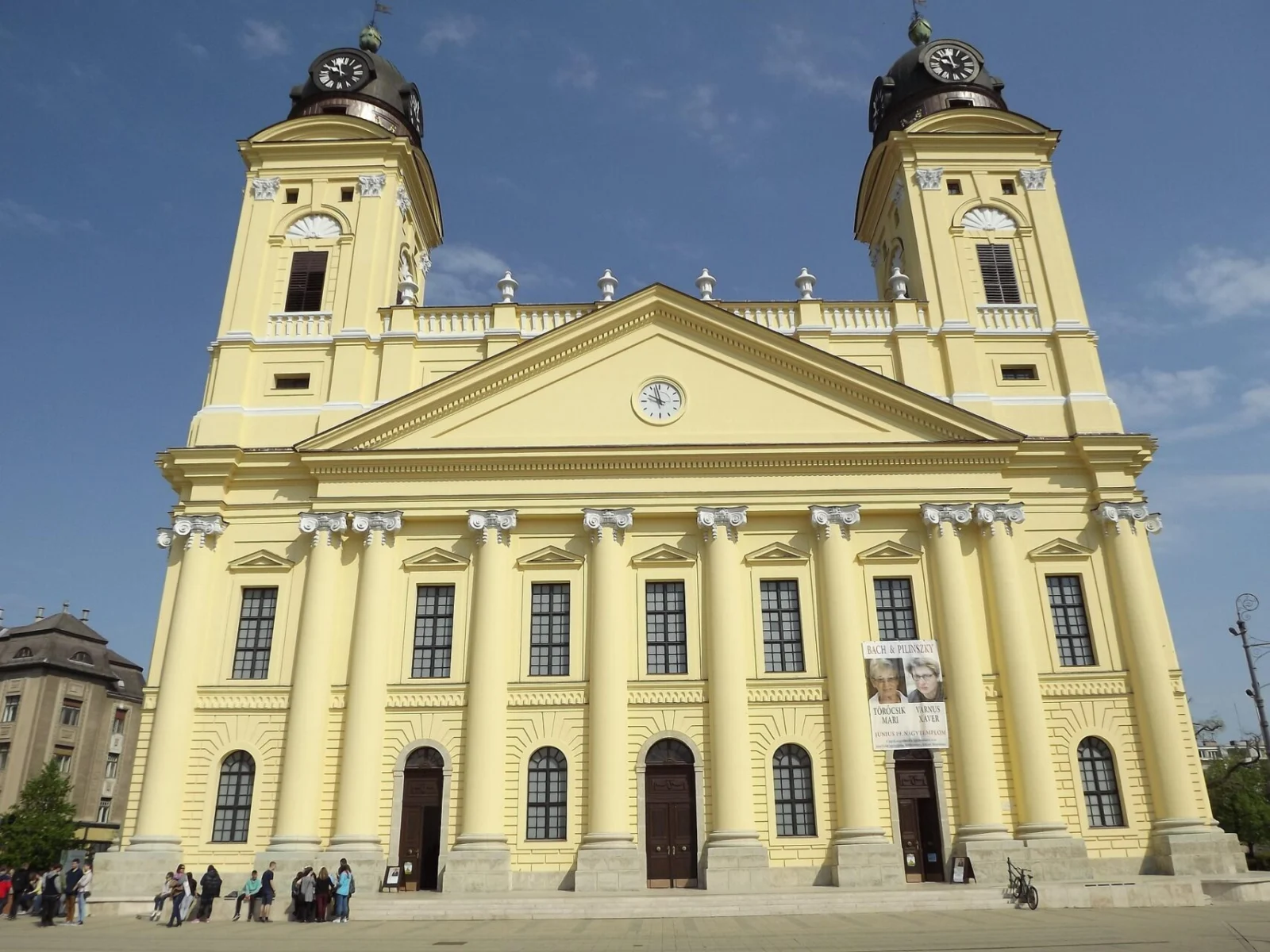 The Great Reformed Church of Debrecen with its twin towers and yellow façade.