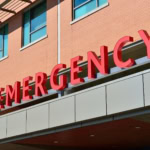 Red “Emergency” hospital sign above entrance — symbolising access to urgent healthcare abroad under the UK GHIC scheme.