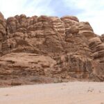 Towering sandstone cliffs in Wadi Rum desert, Jordan