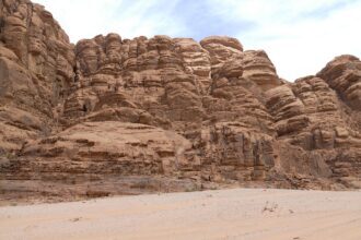 Towering sandstone cliffs in Wadi Rum desert, Jordan