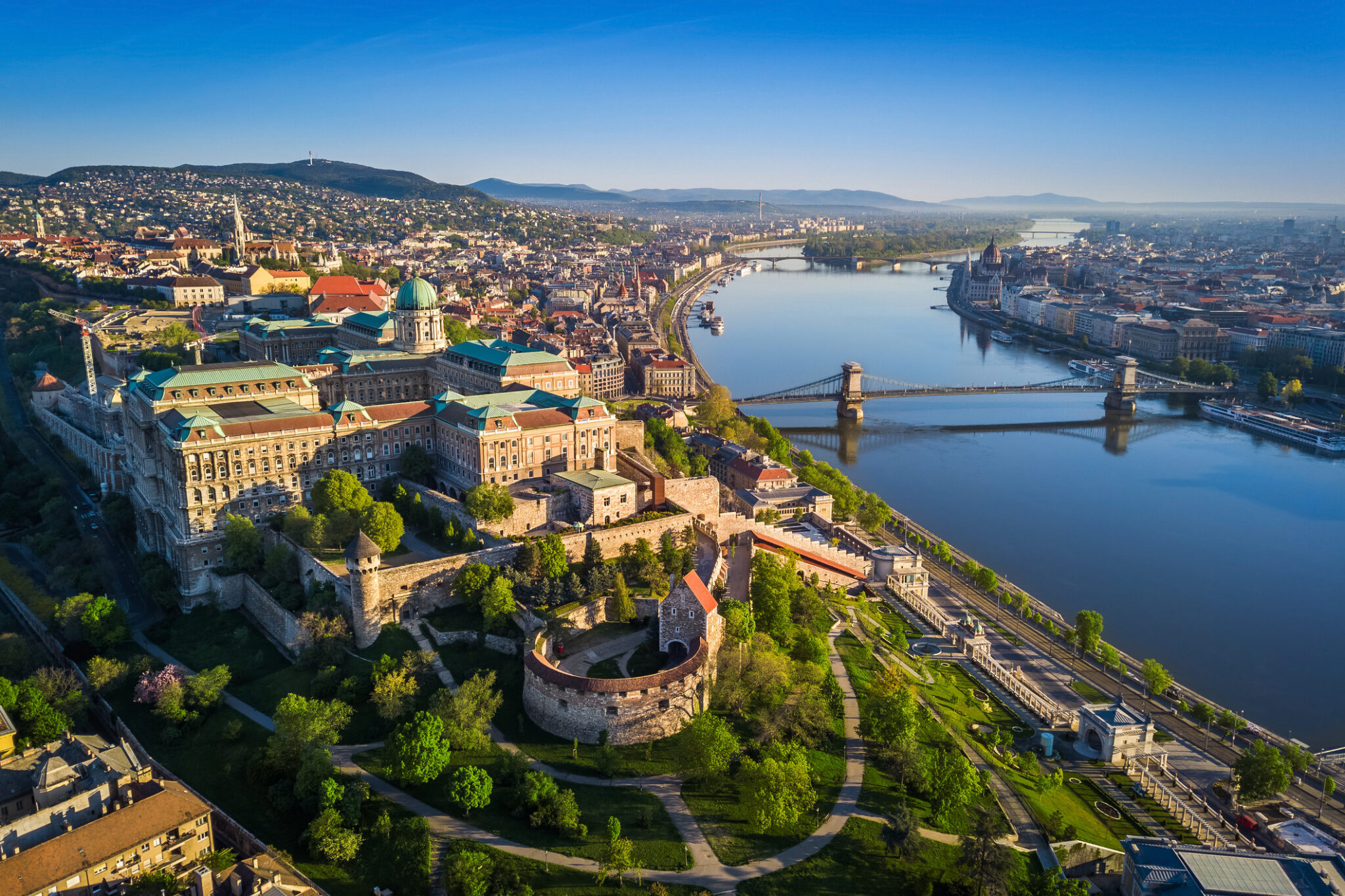 Aerial view of Buda Castle overlooking the Danube River and Chain Bridge in Budapest Hungary