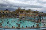 Visitors relaxing in the outdoor thermal pools at Szechenyi Baths in Budapest