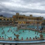 Visitors relaxing in the outdoor thermal pools at Szechenyi Baths in Budapest