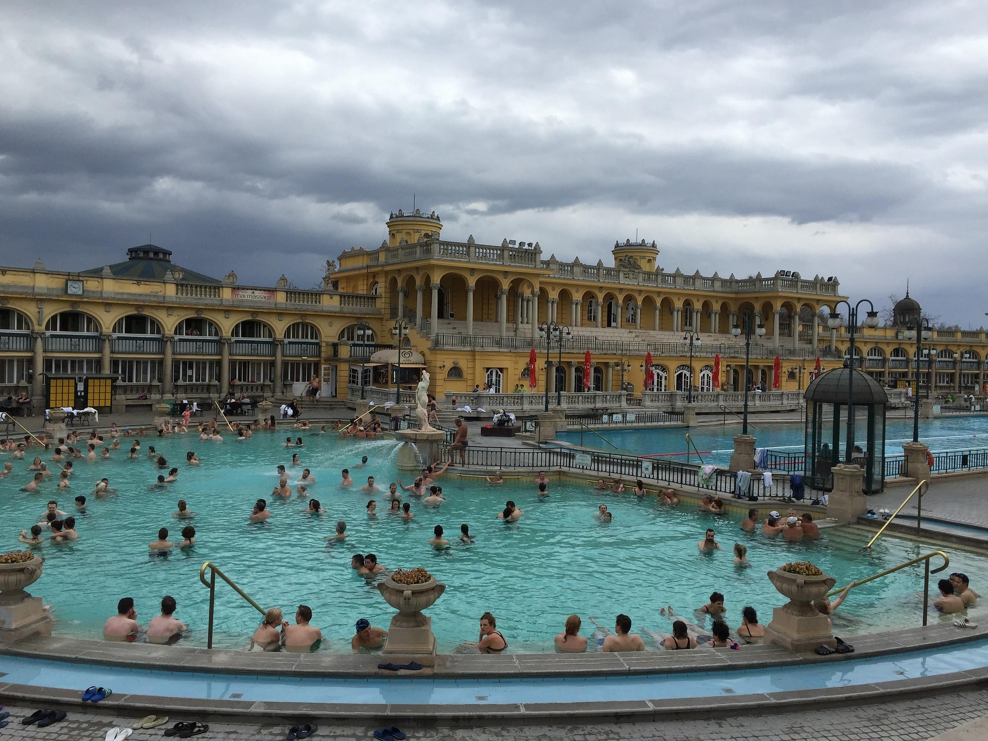 Visitors relaxing in the outdoor thermal pools at Szechenyi Baths in Budapest