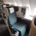 Business class airline seat showing upgraded cabin with lie flat seat and window view