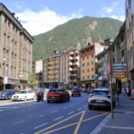 Street in Andorra la Vella with cars driving through mountain town