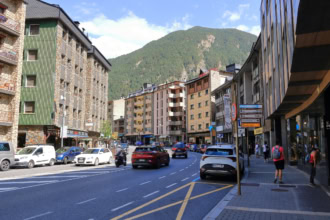 Street in Andorra la Vella with cars driving through mountain town