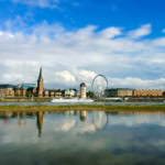 Düsseldorf skyline with Rhine river, ferris wheel and riverside promenade
