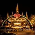 Vienna Christmas market at night in front of Rathaus with festive lights and decorations