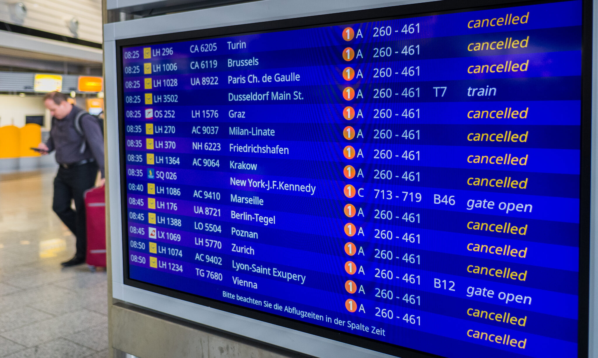 Airport departure board showing multiple cancelled flights