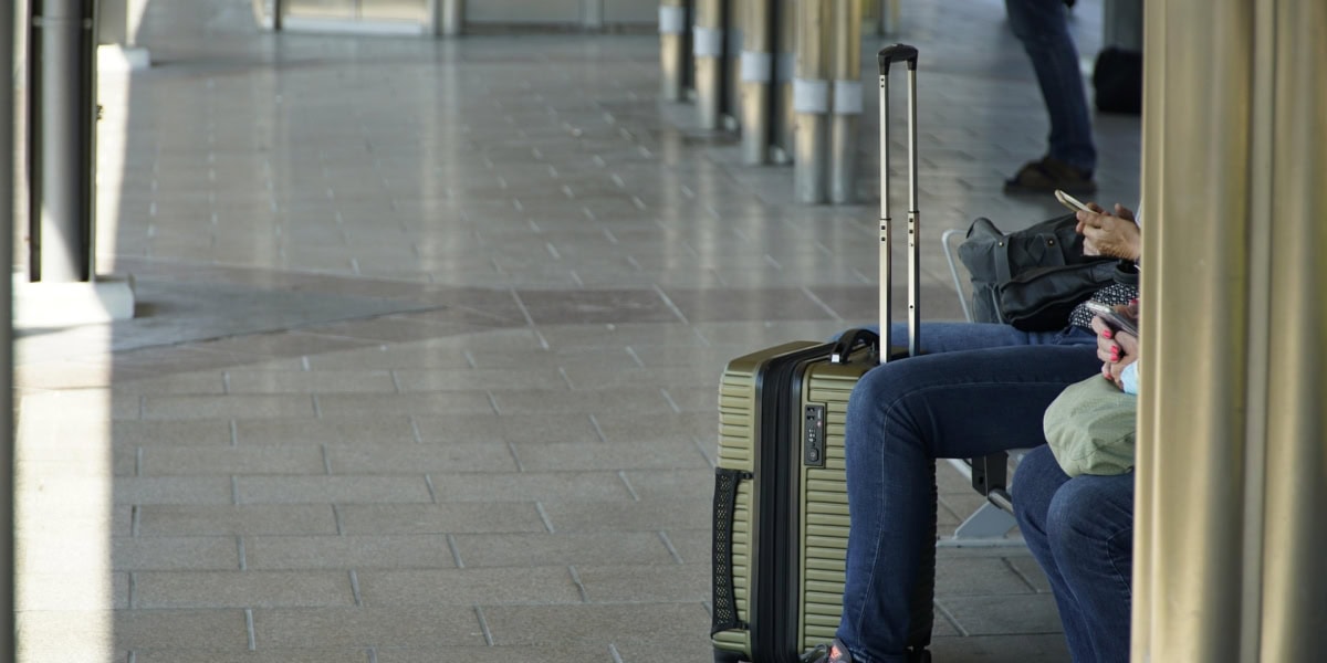 Luggage storage travel โ travellers sitting with suitcases at a train station