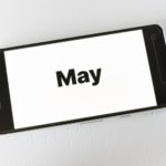 Smartphone screen displaying the word May for travel planning