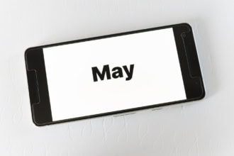 Smartphone screen displaying the word May for travel planning