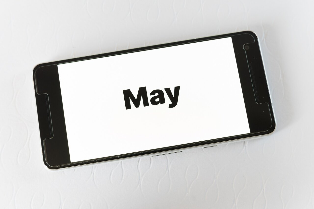 Smartphone screen displaying the word May for travel planning