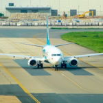 Oman Air aircraft taxiing on runway
