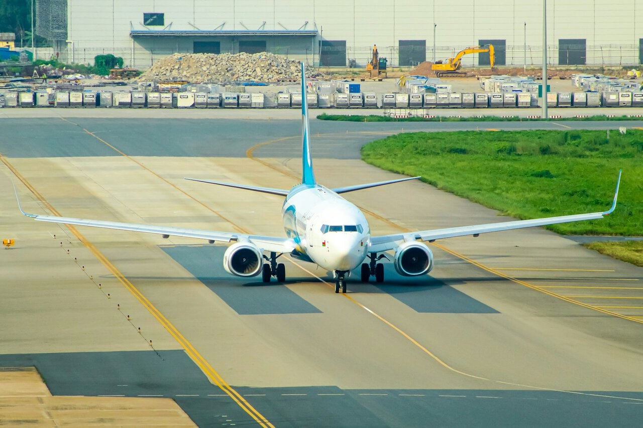Oman Air aircraft taxiing on runway