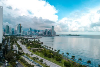 Panama City skyline along the coast with modern skyscrapers and waterfront road